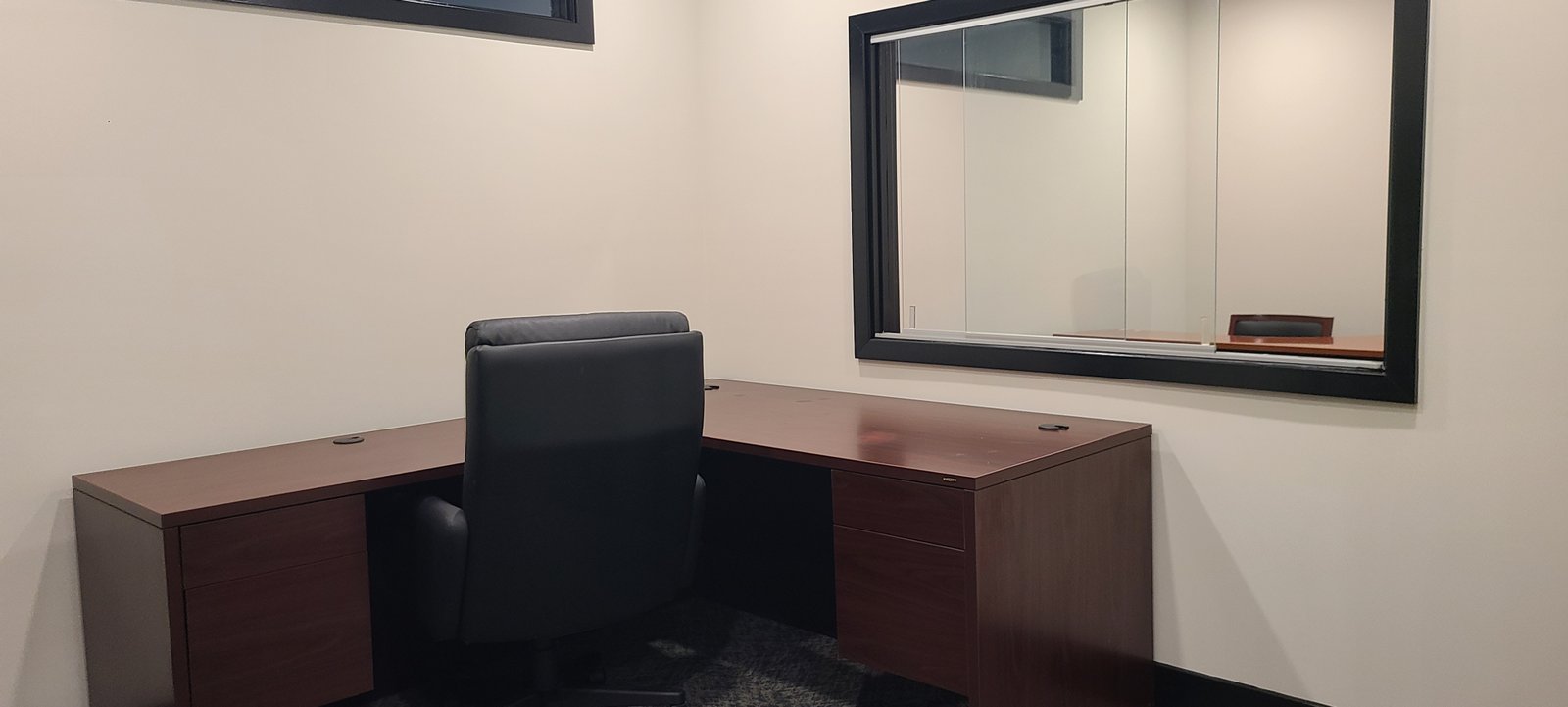 Inside office with desk and wall window