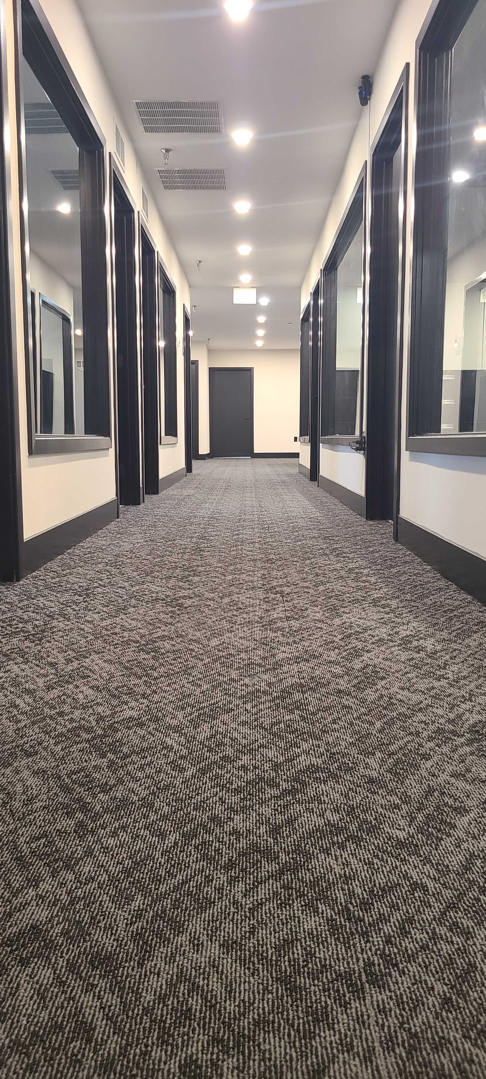 Private office corridor with glass office fronts