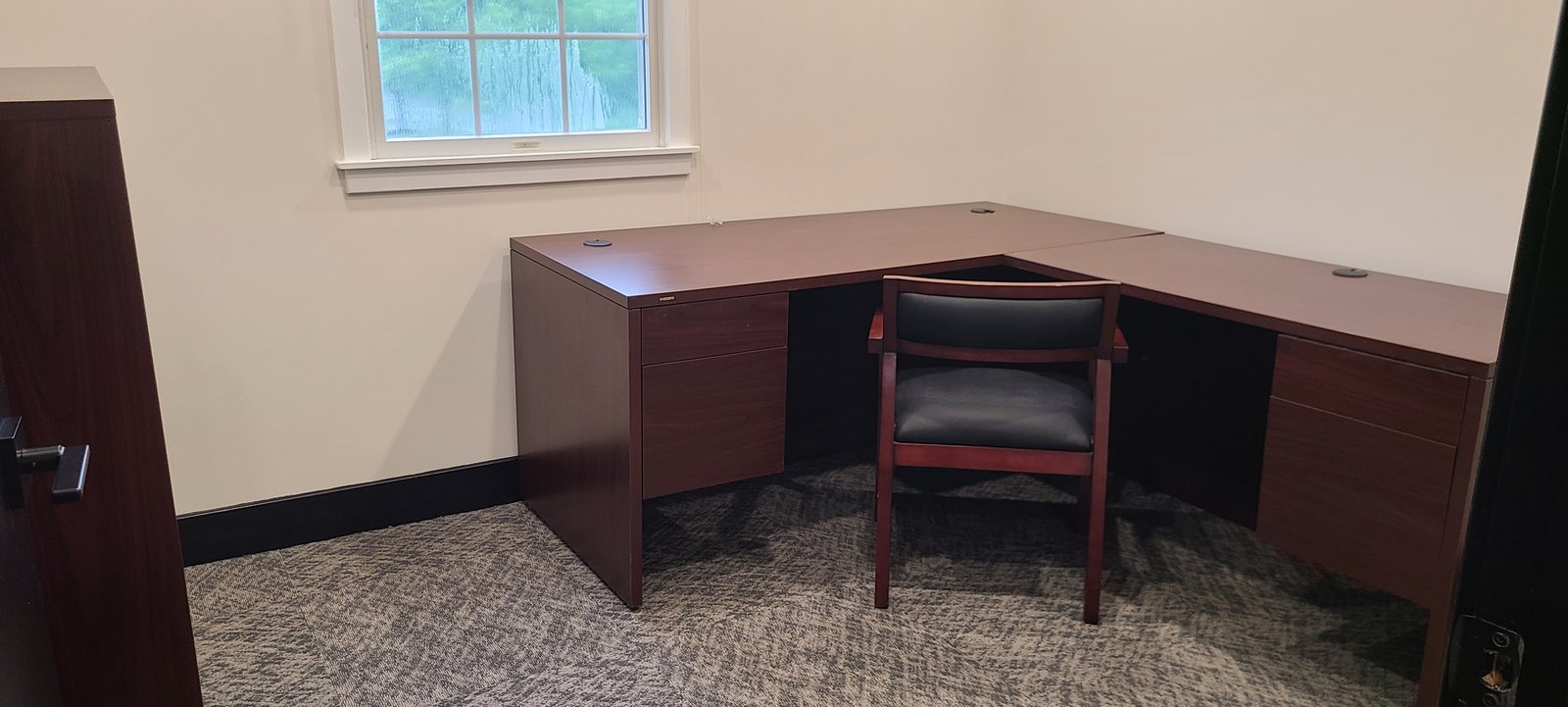 Private office with built-in desk and window